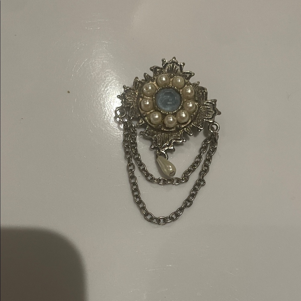 Vintage-Inspired Silver Floral Brooch with Blue Center and Pearl Accents